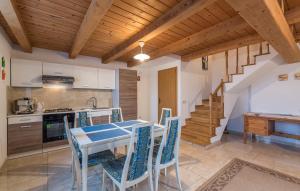 a kitchen with a table and chairs and a staircase at Apartment Paulina in a Stone House in Jakići