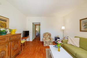 a living room with a couch and a chair at Wine Resort Ledà d'Ittiri in Alghero