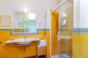 a bathroom with a sink and a shower at Wine Resort Ledà d'Ittiri in Alghero