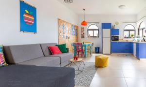 a living room with a couch and a kitchen at Nof Lavon in Lavon