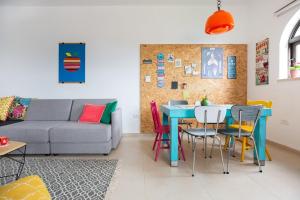 a living room with a couch and a table and chairs at Nof Lavon in Lavon