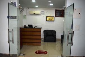 a office with a chair and a desk in a room at White Tulip Residency in Puducherry