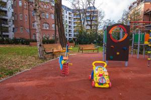 a playground with two toys in a park at Apartamenty Bema od WroclawApartament-pl in Wrocław
