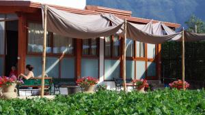 a woman sitting at a table in front of a house at Madre Terra in Pimonte