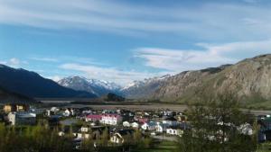 a small town in a valley with mountains in the background at Mirador del Bosque Aparts in El Chalten