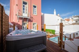 a hot tub on the balcony of a house at aleixomor'Aqui in Loulé
