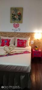 a bedroom with a large bed with red pillows at Decho Hostel in Ko Lipe