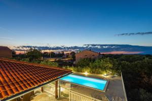 a swimming pool on the roof of a house at Vila Luna Apartments in Zadar