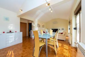 a kitchen and dining room with a table and chairs at Vila Luna Apartments in Zadar