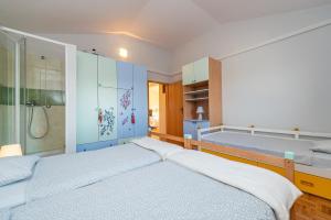 a bedroom with two beds and a shower at Vila Luna Apartments in Zadar +36 photos