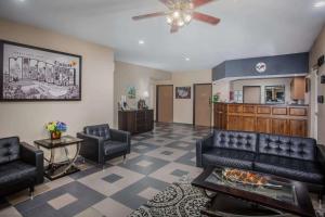 a living room with a couch and chairs and a kitchen at Super 8 by Wyndham Union in Union
