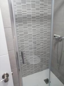 a shower with a glass door in a bathroom at Estudio FARO TORROX in Torrox Costa