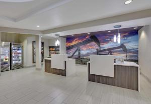 a store lobby with a hockey mural on the wall at La Quinta by Wyndham Big Spring in Big Spring
