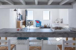 a living room with a large table and chairs at Almyra Guest Houses in Paraga