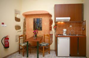 a small kitchen with a small table and a sink at Iason Studios in Chania