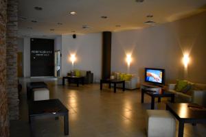 a lobby with couches and a flat screen tv at Aspen Ski and Golf Resort in Bansko