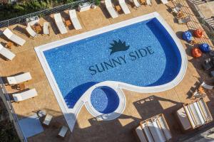 an overhead view of a swimming pool at a resort at Sunny Side Wellness Resort & Spa in Budva