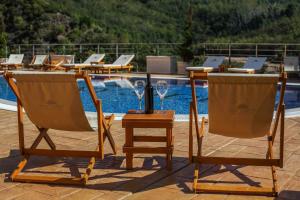 two chairs and a table with wine glasses on it at Sunny Side Wellness Resort & Spa in Budva