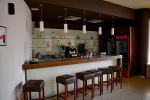 a bar with stools in a restaurant with a counter at Aspen Ski and Golf Resort in Bansko