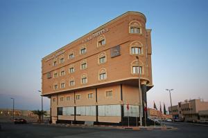 a large brick building on the side of a street at Etab Hotels & Suites in Al Khobar