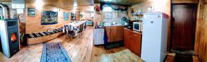 a kitchen with wooden floors and a refrigerator in a trailer at Villa Vanessa Koprivki Area in Tsar Kaloyan