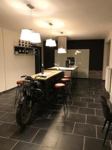 een motorfiets geparkeerd in een kamer met een keuken bij Bij de lindeboom in Maaseik