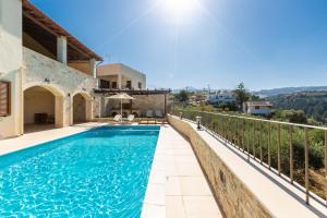 a swimming pool in a villa with a view at Ilys Home, Country Retreat, By ThinkVilla in Margarítai