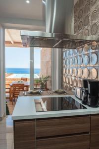 a kitchen with a view of the ocean at Villa del Mar Esquinzo Jandia Fuerteventura in Playa Jandia
