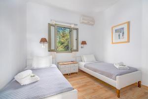 Posteľ alebo postele v izbe v ubytovaní Kosyforema Villas