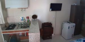 a kitchen with a sink and a refrigerator at Araçatiba Flat in Praia de Araçatiba