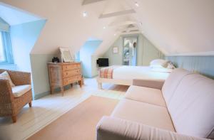 a bedroom with a bed and a couch at The Apartments @ Quidhampton Mill in Salisbury