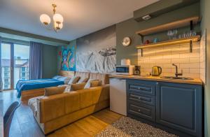 a living room with a couch and a bed at AlteRoom New Gudauri, Loft 2-457 Near Gondola lift in Gudauri