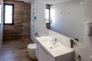 a bathroom with a white sink and a toilet at Loft del Mar 1 Jandia in Playa Jandia +20 photos