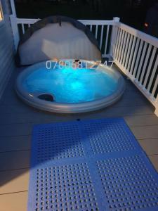 a jacuzzi tub on the deck of a house at J S RETREATS @ TATTERSHALL LAKES in Tattershall