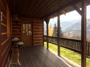 a porch of a cabin with a view of the mountains at Penzion Bouda Tonička in Pec pod Sněžkou