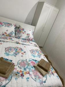 a bedroom with a bed with a floral bedspread at Jerusalem Old City room in Yerushalayim