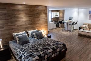 a bedroom with a large bed and a kitchen at Loft del Mar 2 Jandia in Playa Jandia