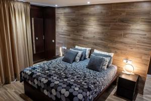プラヤ・ハンディアにあるLoft del Mar 2 Jandiaの木製の壁のベッドルーム1室(大型ベッド1台付)