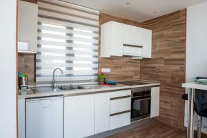 a kitchen with white cabinets and a sink at Loft del Mar 2 Jandia in Playa Jandia