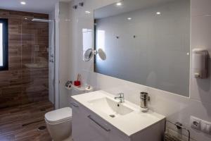 a bathroom with a sink and a toilet and a mirror at Loft del Mar 2 Jandia in Playa Jandia +17 photos