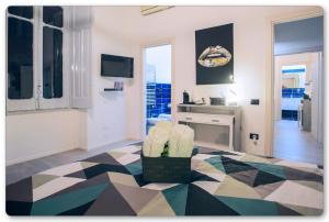 a living room with a geometric patterned floor at B&B Palazzo Di Florio in Cava deʼ Tirreni +22 photos