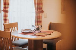 a small wooden table with a bowl on top of it at Appartements Wieshof in Sankt Johann im Pongau