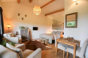 a living room with a couch and a table at De Rolders in Wapenveld