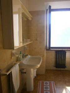 a bathroom with a white sink and a window at CASA IN RIVA AL LAGO in Varenna +44 photos