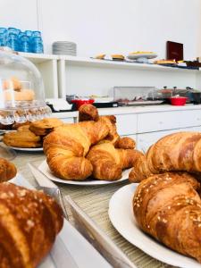 a bunch of breads on plates on a table at Hotel Nautilus in Cagliari