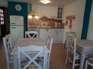 a kitchen with a table and chairs and a refrigerator at Casa Vivaldi in Velingrad