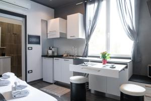 a kitchen with white cabinets and a sink and a window at Villa Azur Cap d'Ail in Cap d'Ail
