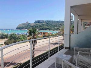 a balcony with a view of the beach and mountains at Hotel Nautilus in Cagliari