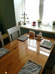 a dining room table with chairs and a wooden table at Sweet-S in Boryspilʼ