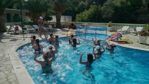 a group of people playing in a swimming pool at Ilias Studios sevasti in Panormos Kalymnos